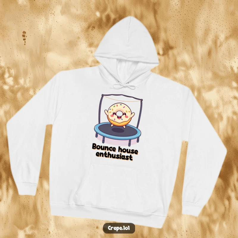 Funny happy donut with sprinkles performing an epic bounce on a trampoline, featured on a warm and comfortable hoodie.