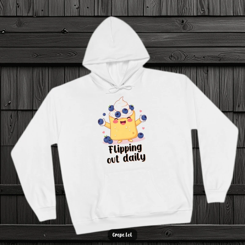 Funny hoodie depicting a happy crepe with whipped cream arms, masterfully juggling a pile of fresh blueberries.