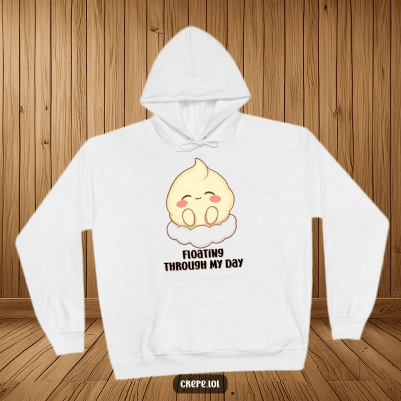 Funny hoodie featuring a happy crepe character humming with eyes closed, floating dreamily on a soft cloud, promoting comfort.