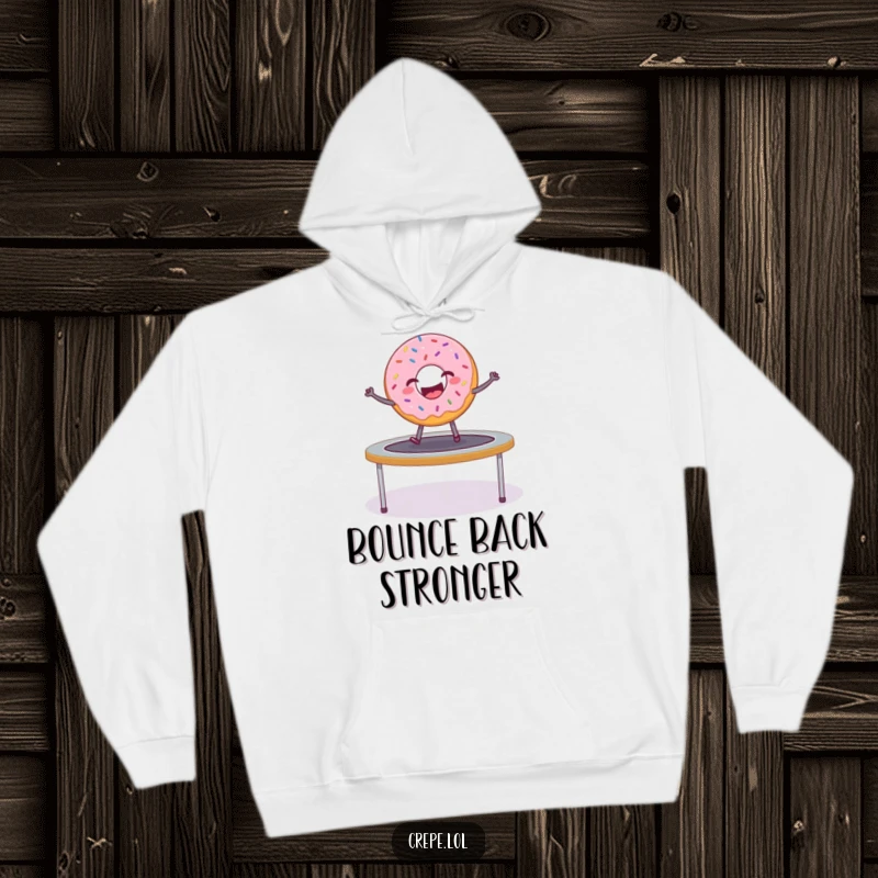 Funny donut with sprinkles bouncing energetically on a trampoline, featured on a warm hoodie.