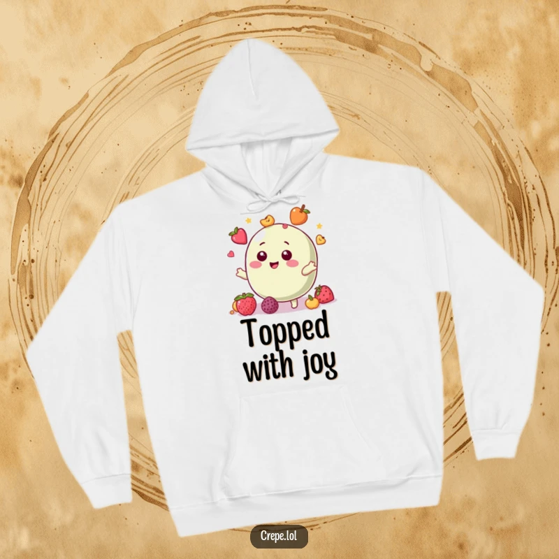 Funny hoodie showcasing a giggling macaron character in the act of juggling small, colorful fruit toppings.