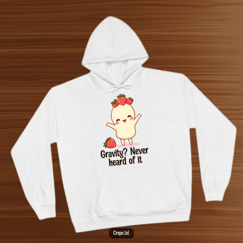 Funny hoodie featuring a cute crepe with a strawberry crown, captured mid-playful flip, perfect for cozying up with smiles.