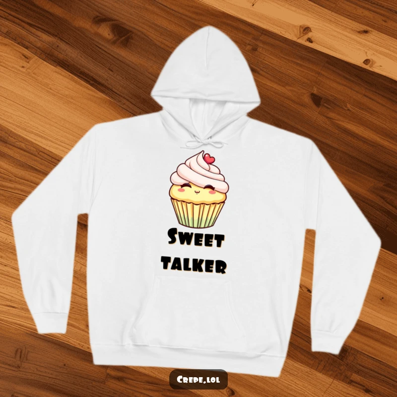 Funny hoodie depicting a joyful cupcake with luscious frosting, puckering its lips to blow a heartwarming kiss, radiating sweetness.