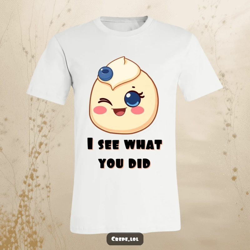 Funny t-shirt depicting a crepe with a blueberry eye, giving a bright and joyful wink, full of personality.